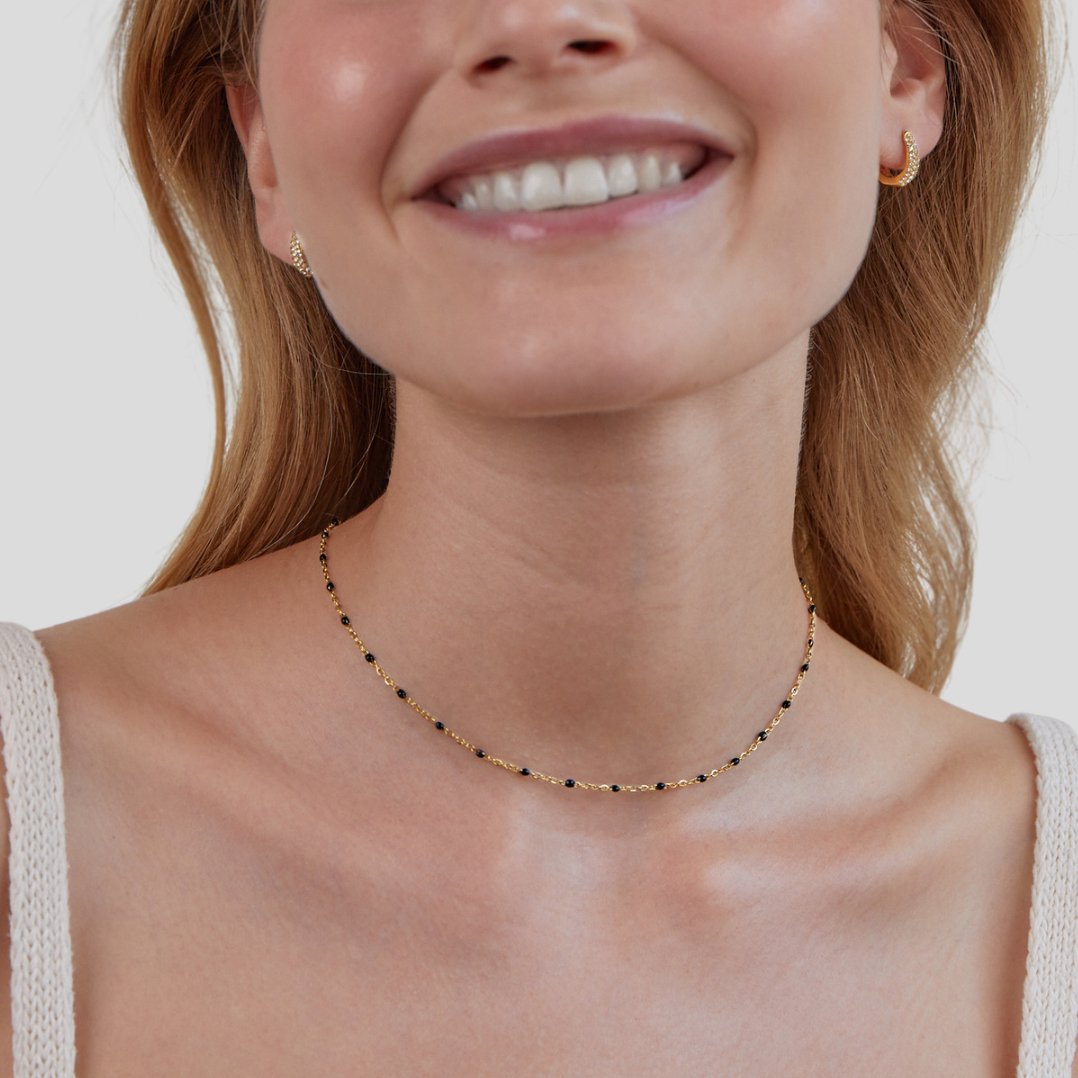 Mila Black Bead Necklace, worn on a smiling model with a cream knit top