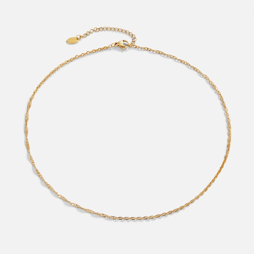 Mila Twist Gold Chain Necklace, laid flat on a light grey background, twisted gold chain with clasp