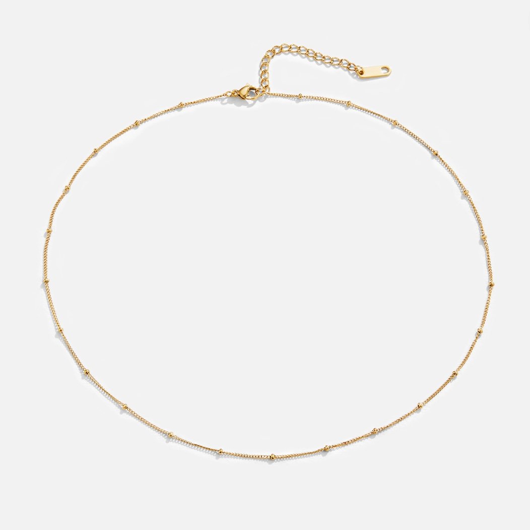 Niyah Bead Gold Chain Necklace, laid flat on white, thin gold chain with tiny beads and