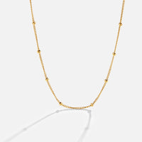 Niyah Bead Gold Chain Necklace, gold chain with small evenly spaced beads on white background