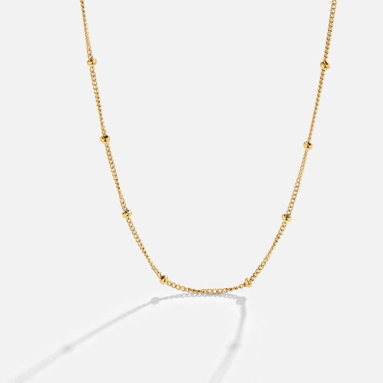 Niyah Bead Gold Chain Necklace, gold chain with small evenly spaced beads on white background