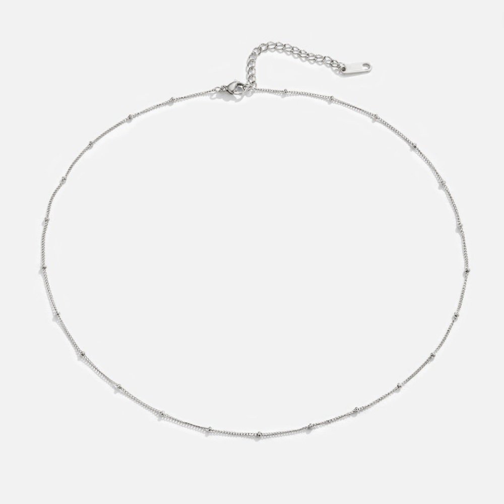 Niyah Bead Silver Chain Necklace, laid flat on white background, fine silver chain with small
