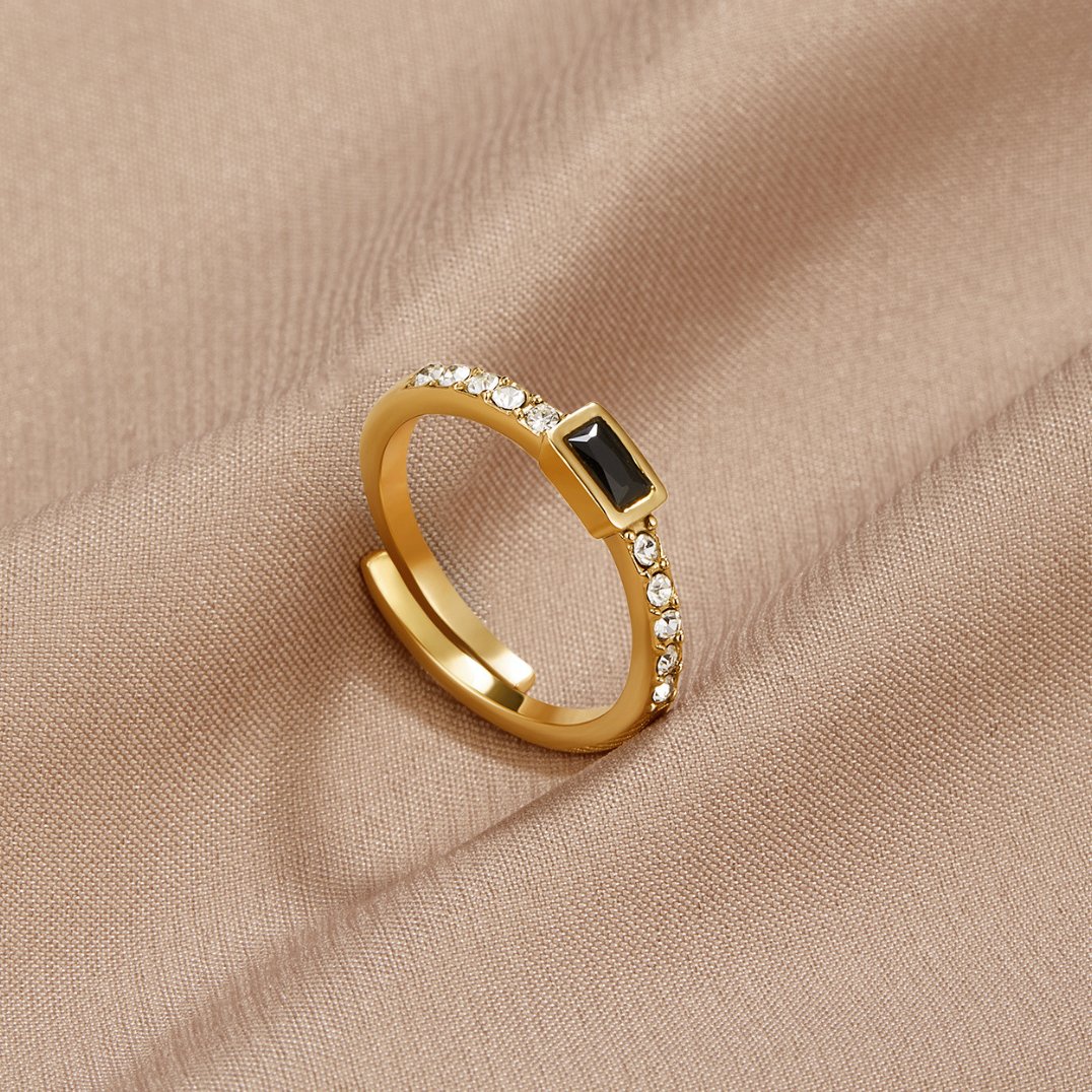 Onyx Black Crystal Ring, gold ring on beige satin with a black baguette stone