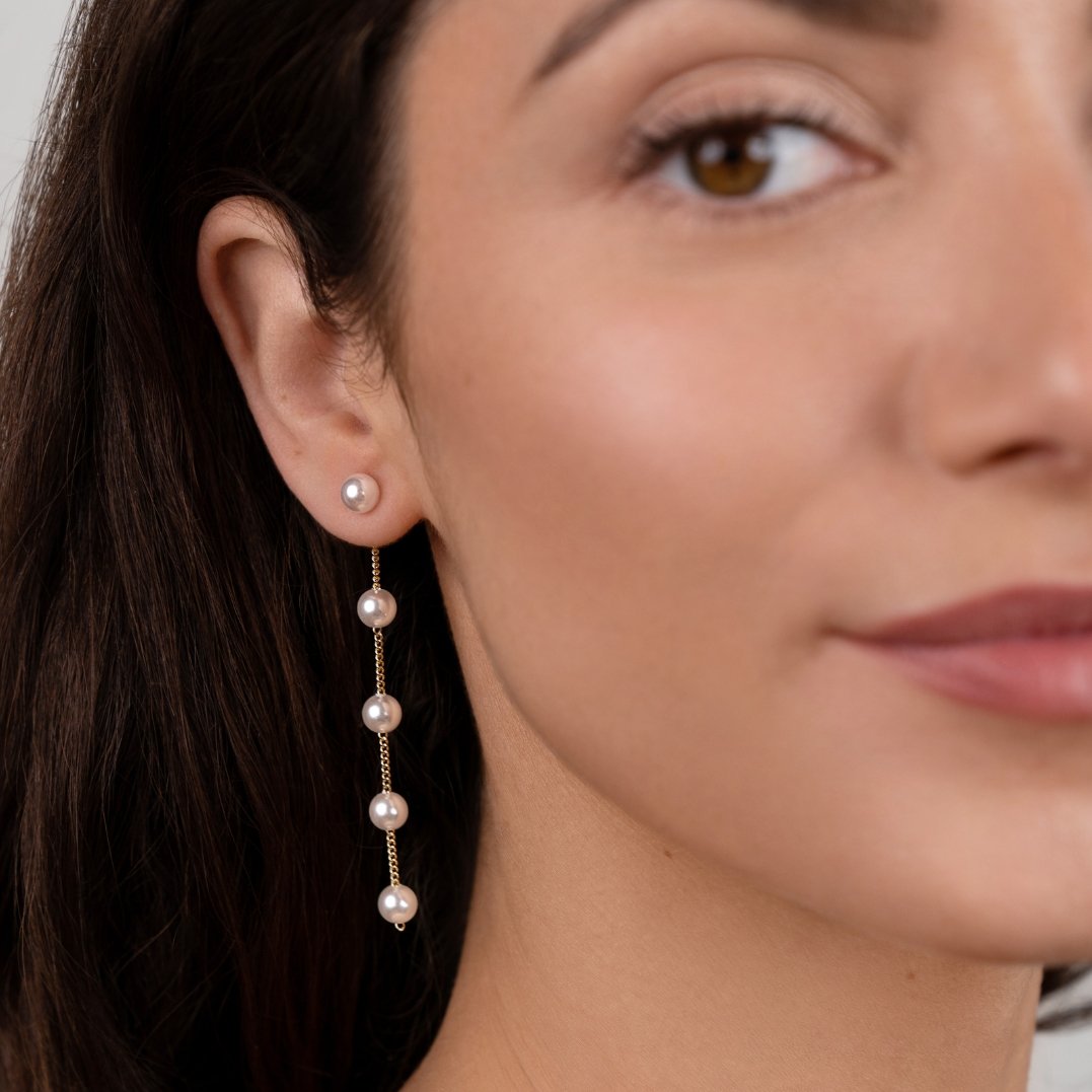 Pearl Drop Earrings, worn on an ear with a pearl stud and gold chain drop