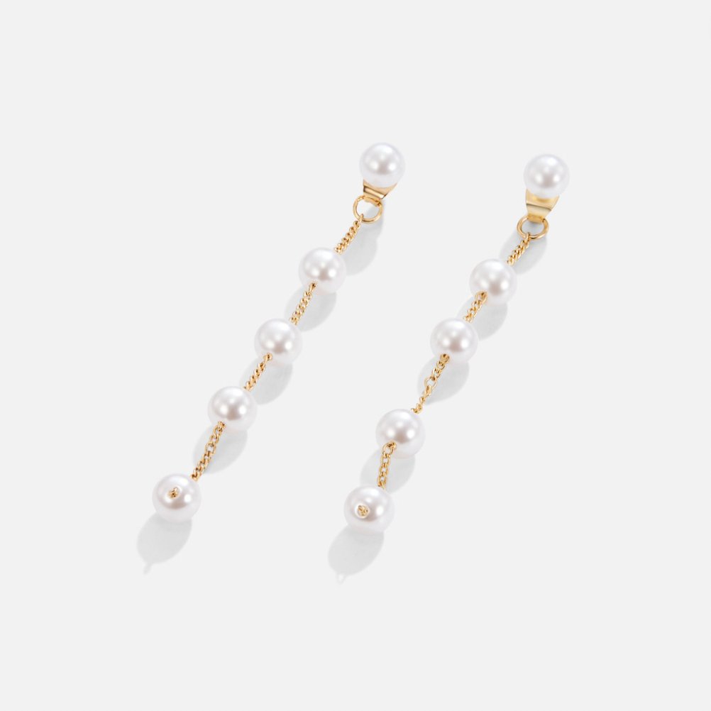 Pearl Drop Earrings, pair of drop earrings laid flat on white, pearls on gold chain