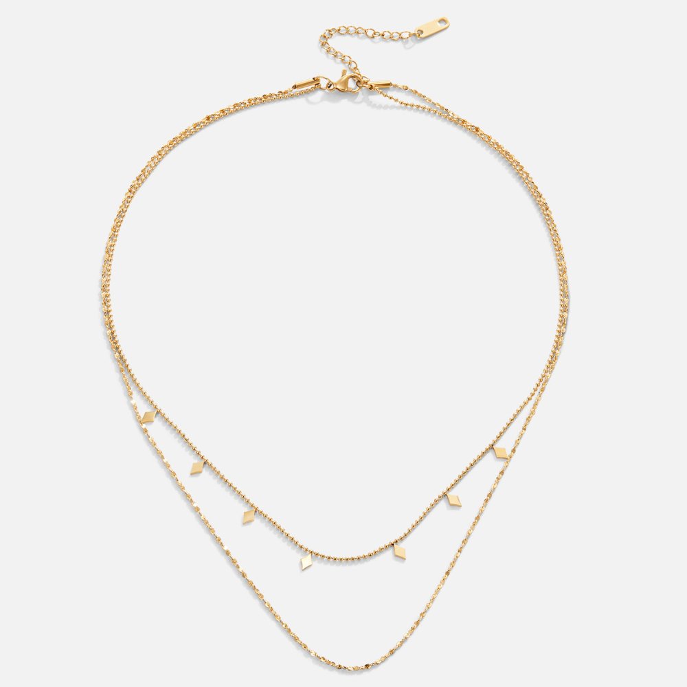 Phoenix Layered Necklace, flat lay of two gold chains with diamond-shaped drops