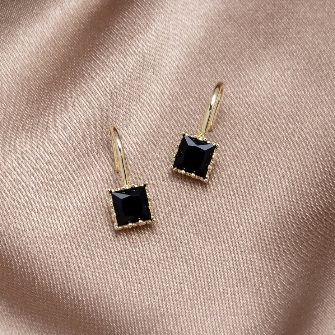 Piper Black Crystal Drop Earrings, pair of earrings on satin, black square stones in gold settings