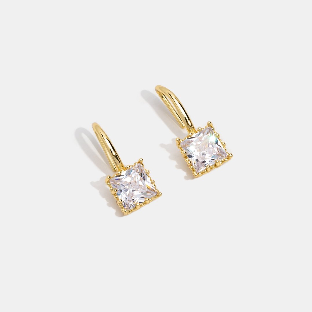 Piper Crystal Drop Earrings, pair of gold earrings with square clear stones on white background