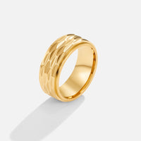 Rene Chunky Gold Ring, standing upright on white, textured band with smooth inner edge