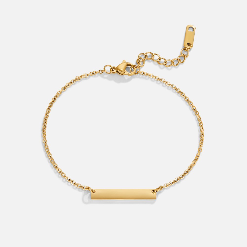 Rina Gold Bar Bracelet, flat lay of a gold chain bracelet with a polished bar, on white
