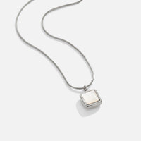 Riva Moonstone Pendant Necklace, laid flat on white, silver chain with square white pendant