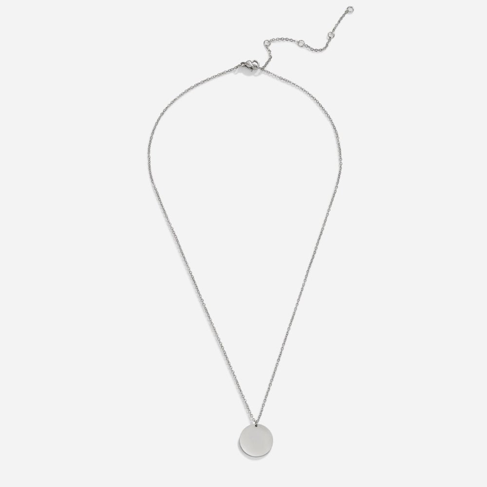 Silver Coin Necklace, flat lay of a fine chain with a round silver disc pendant