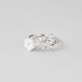 Silver White Blossom Flower Ring, lying flat on grey, open band with white flower and leaf