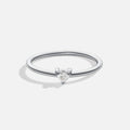 'Small Love' Crystal Heart Ring, standing alone on plain light background, thin silver band