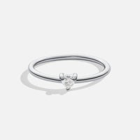 'Small Love' Crystal Heart Ring, standing alone on plain light background, thin silver band
