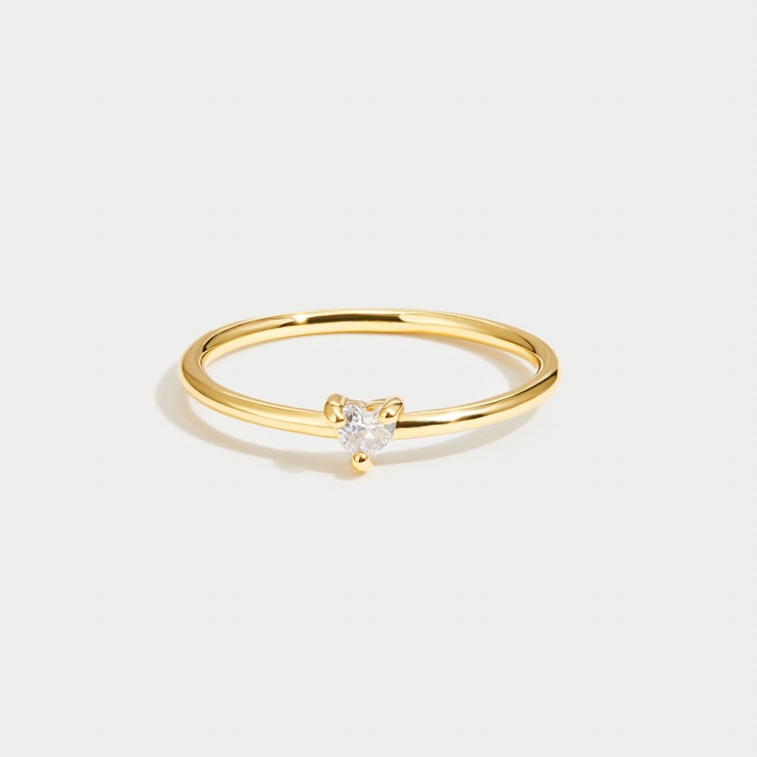'Small Love' Crystal Heart Ring, thin gold band with a small clear heart stone in a prong setting