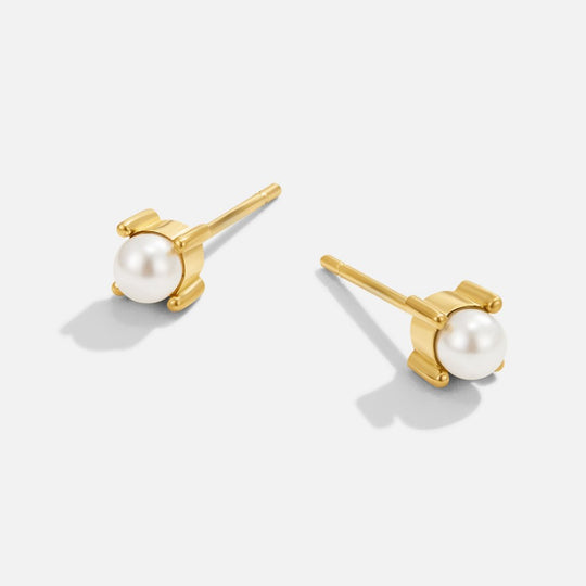 Free Sofia Pearl Stud Earrings, pair of gold stud earrings with white pearls on light grey