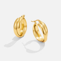 Talia Gold Hoop Earrings, pair of gold hoop earrings on a plain white background