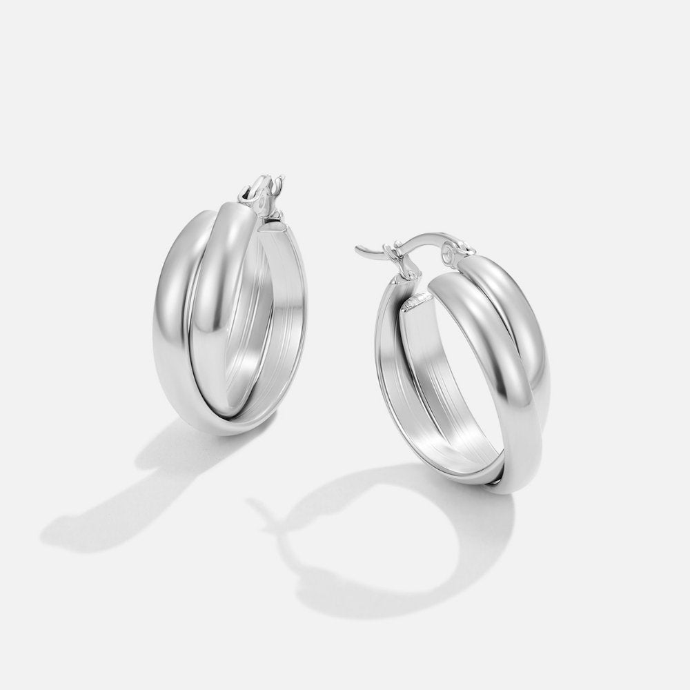 Talia Silver Hoop Earrings, pair of silver hoops on white, angled view with cast shadows