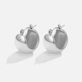 Tara Silver Chunky Hoop Earrings, pair of polished silver puffy hoop earrings on a plain background