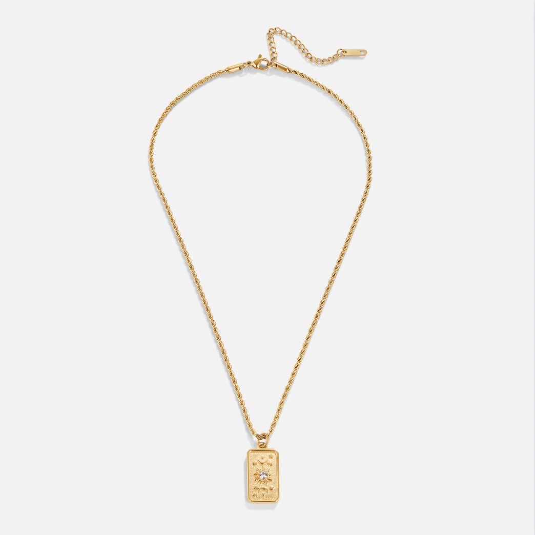 ‘The Sun’ Tarot Pendant Necklace, flat lay of gold rope chain with rectangular pendant, on