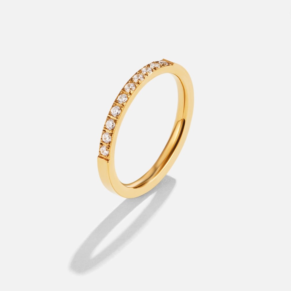 Timeless Beauty 18K Crystal Ring, standing upright on white, gold band with a row of small