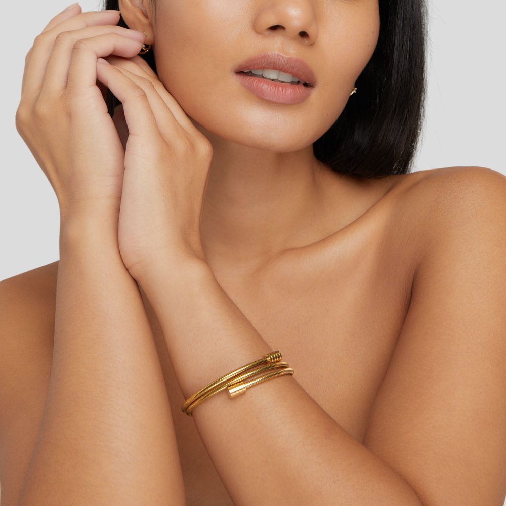 Twisted Gold Bracelet, worn on a wrist with ribbed gold coils wrapped twice