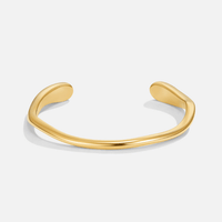 Veena Gold Bangle, polished gold cuff on a plain white background, open at the top