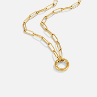 Via Gold Chain Necklace, gold paperclip chain draped on white with a round clasp ring
