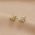 Vintage Blue Opal Stud Earrings, a pair of studs on beige fabric, gold with opal centres