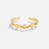 Wavey Pearl 18K Gold Ring, flat on white, open wavy band with small pearls set along it
