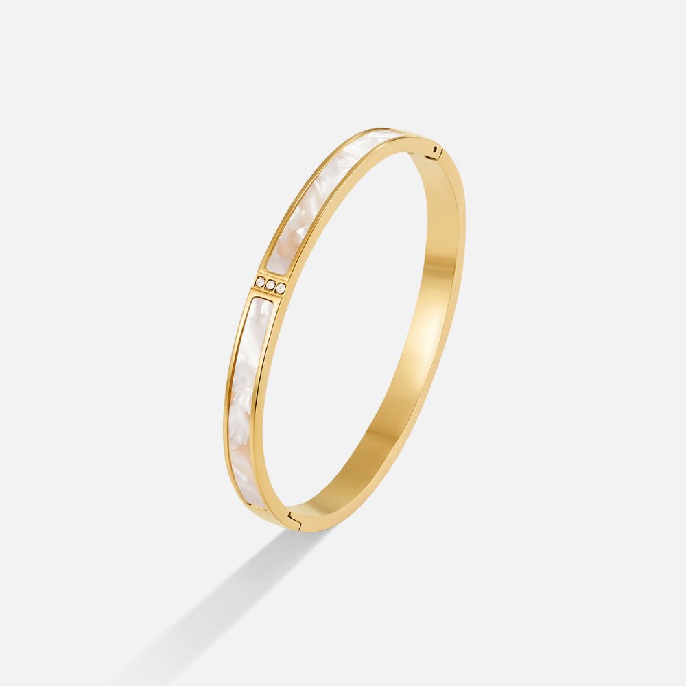 White Sahara Gold Bangle, standing alone on a white background, angled view, gold with white