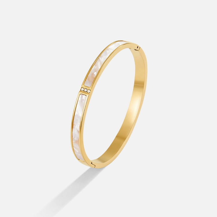 White Sahara Gold Bangle, standing alone on a white background, angled view, gold with white