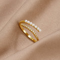“Wrap Me” Pearl & Crystal Ring, gold open wrap ring with pearls and crystals, on beige satin